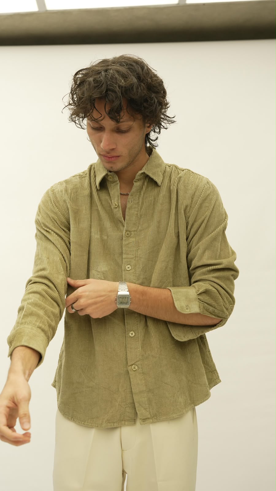 Olive corduroy shirt, sleeve being rolled