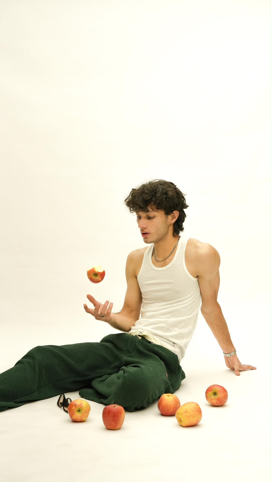White ribbed tank styled with green trousers